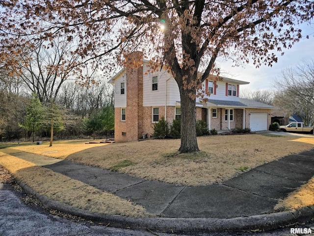 front facade featuring a garage and a front lawn