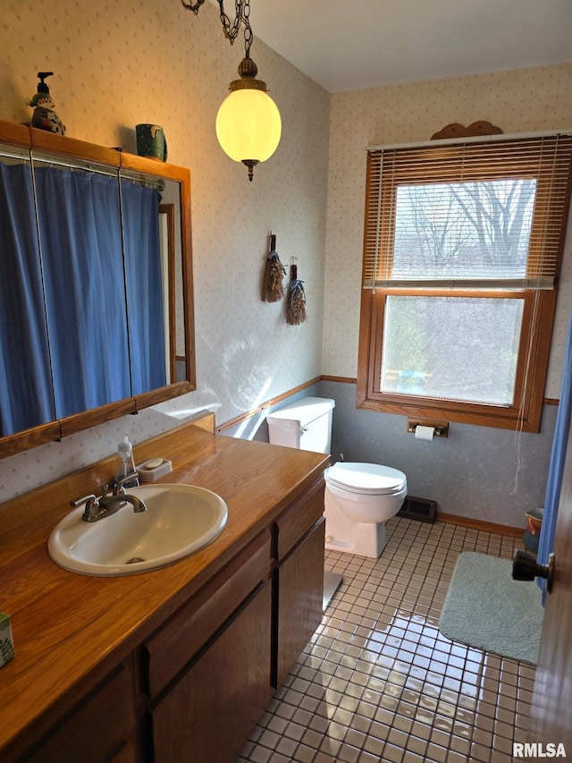 bathroom featuring vanity, curtained shower, tile patterned floors, and toilet