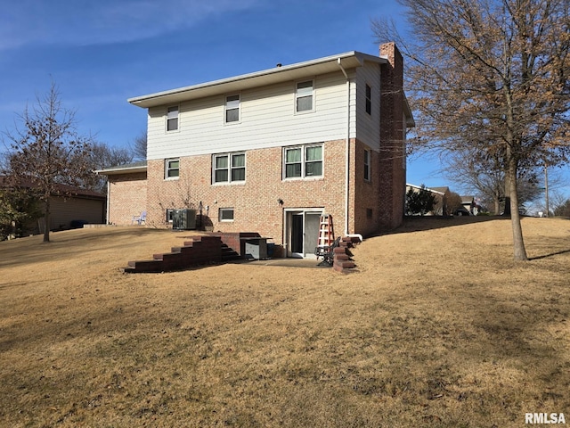 back of property featuring central AC unit and a lawn