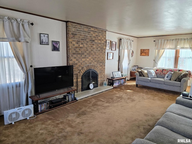 living room with ornamental molding, a brick fireplace, and carpet floors