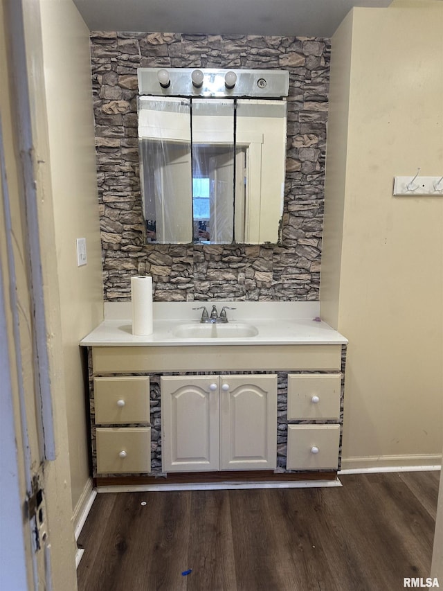 bathroom with hardwood / wood-style flooring and vanity