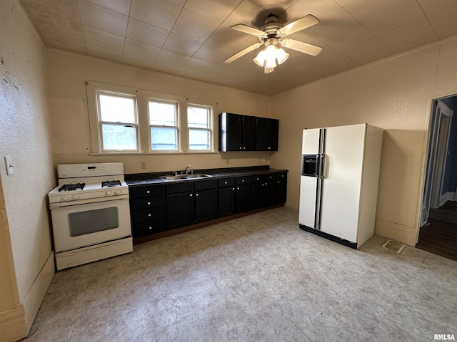 kitchen featuring ceiling fan, sink, and white appliances