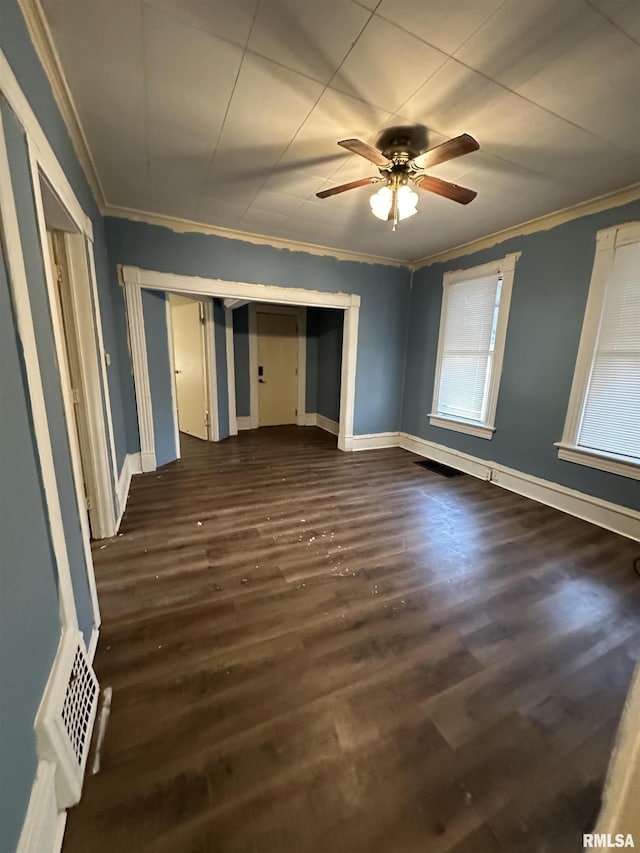 interior space with ornamental molding, dark hardwood / wood-style floors, and ceiling fan