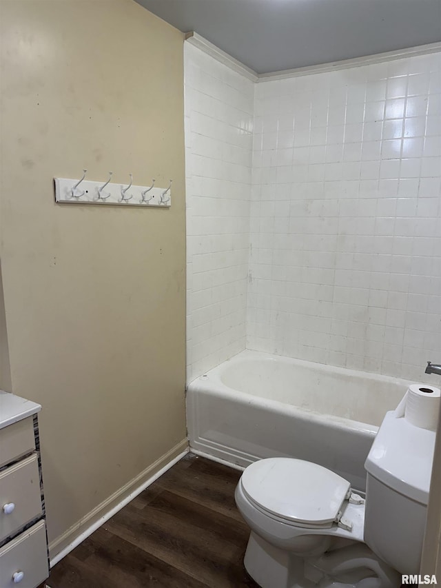 bathroom with vanity, hardwood / wood-style floors, a washtub, and toilet