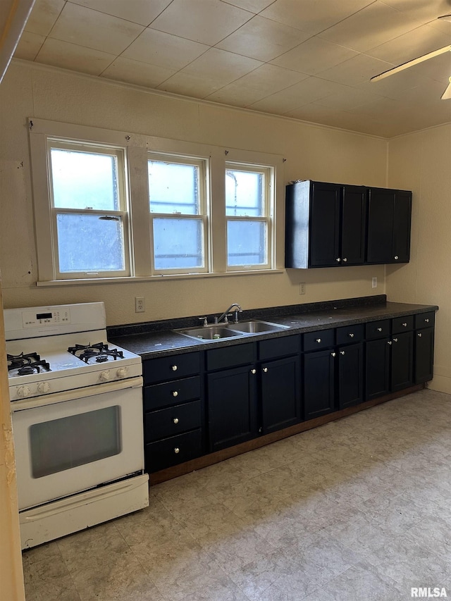 kitchen featuring sink, ceiling fan, and gas range gas stove