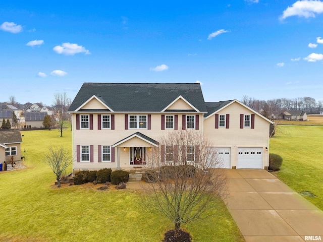 view of front of home with a garage, concrete driveway, and a front lawn