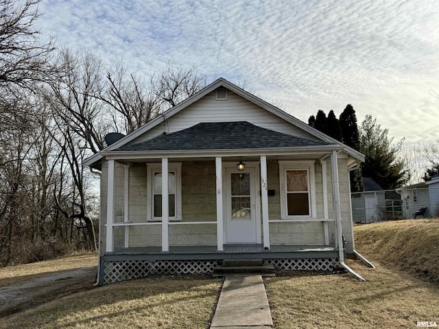 bungalow featuring a porch and a front yard