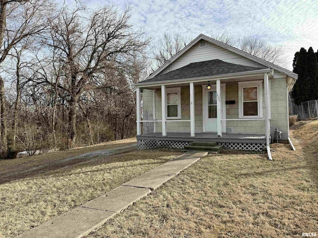 bungalow featuring a front lawn and a porch