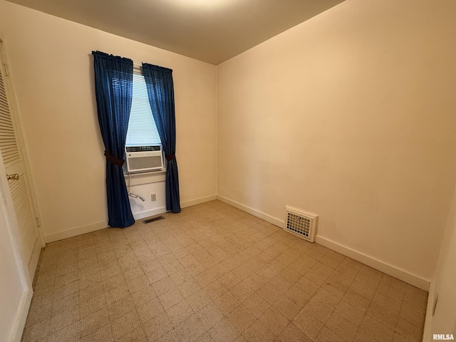 unfurnished room with cooling unit