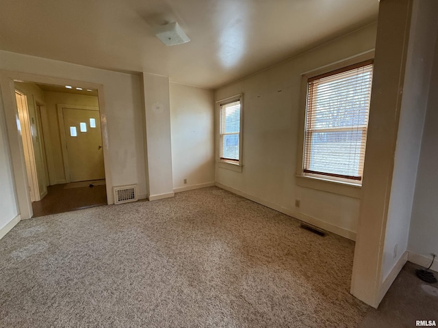 spare room with light colored carpet