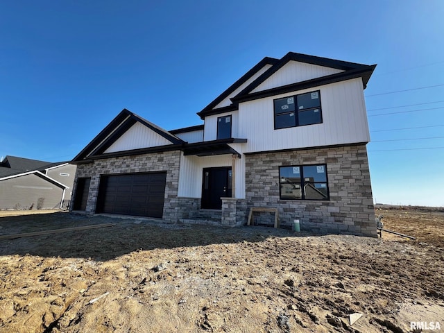 view of front of home featuring an attached garage and stone siding