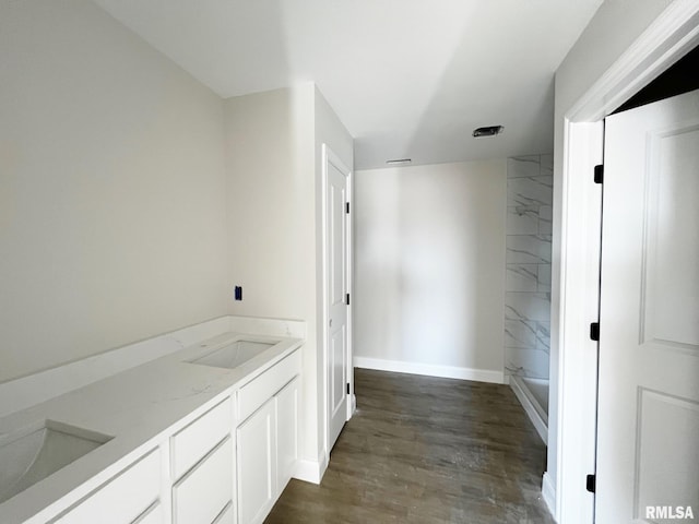 full bathroom with wood finished floors, a shower, baseboards, and a sink