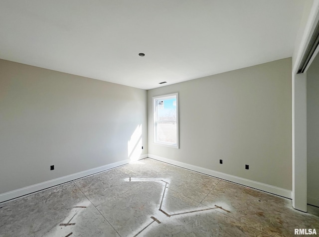 unfurnished room featuring visible vents and baseboards