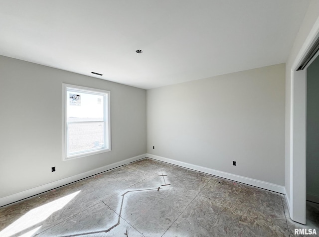 unfurnished room featuring visible vents and baseboards