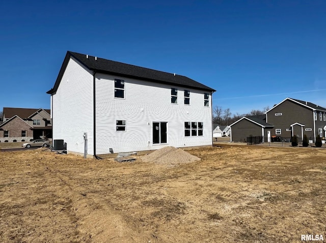 rear view of property with central AC unit