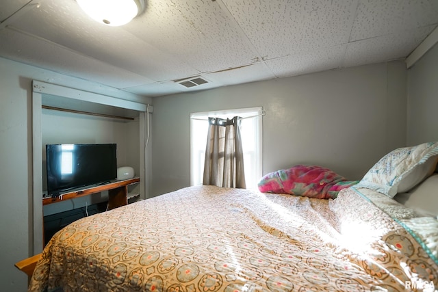 bedroom featuring a drop ceiling