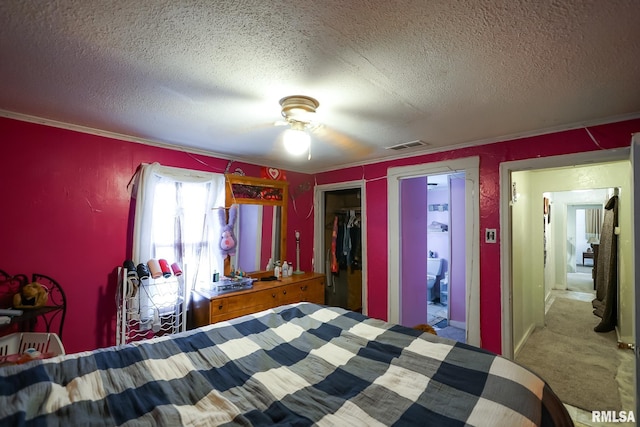 bedroom featuring ceiling fan, carpet floors, a closet, and a textured ceiling