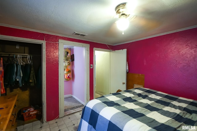 bedroom with ornamental molding, a closet, and a textured ceiling