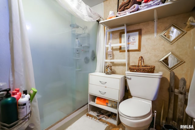 bathroom featuring an enclosed shower and toilet