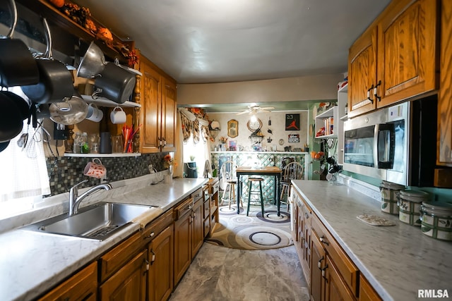 kitchen with sink, backsplash, and ceiling fan