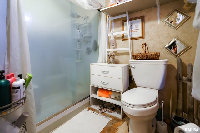 bathroom featuring toilet and an enclosed shower