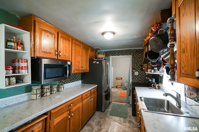 kitchen with stainless steel appliances, sink, and light stone counters