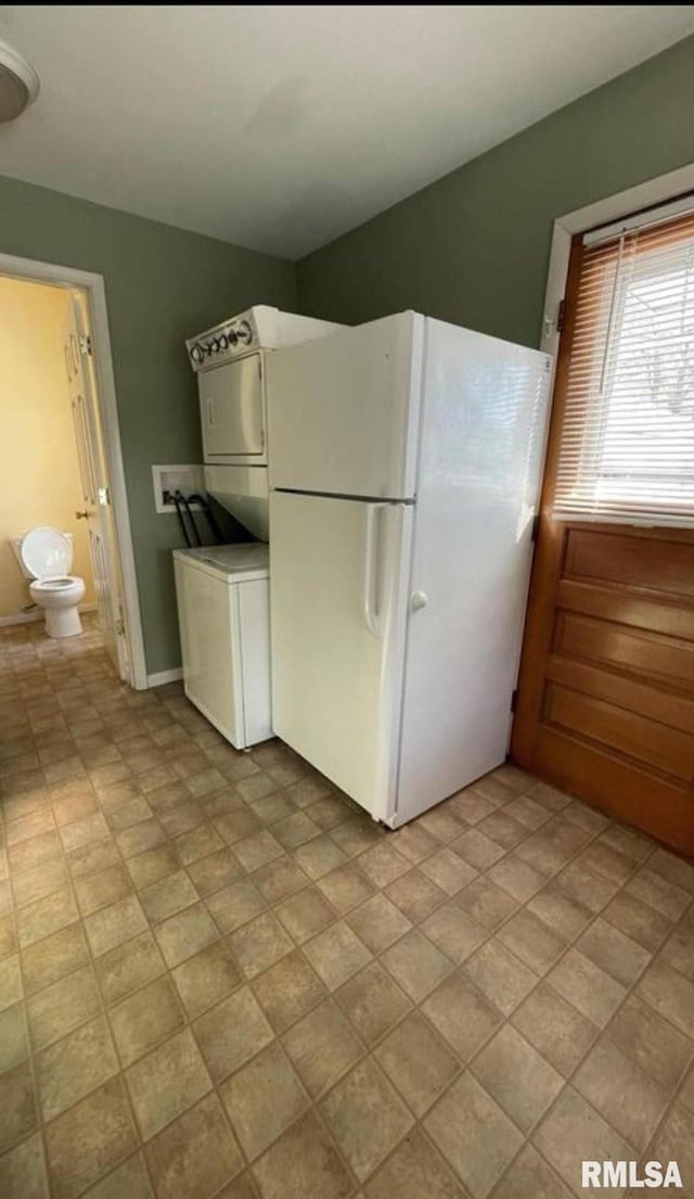 kitchen with white cabinetry and white fridge