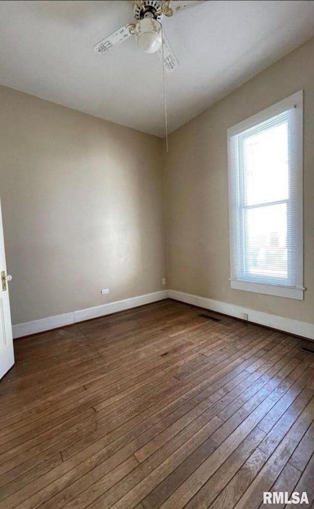 spare room with ceiling fan and dark hardwood / wood-style flooring