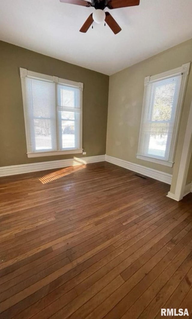 unfurnished room featuring dark hardwood / wood-style flooring and ceiling fan