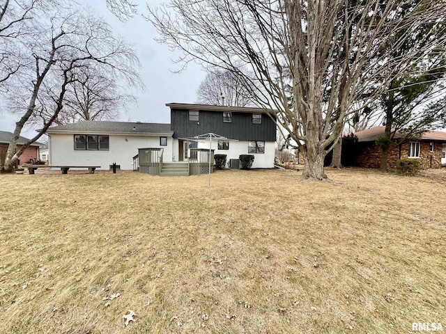 back of property featuring a lawn