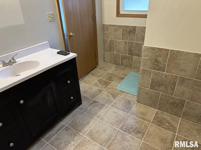 bathroom with vanity, tile patterned flooring, and tile walls