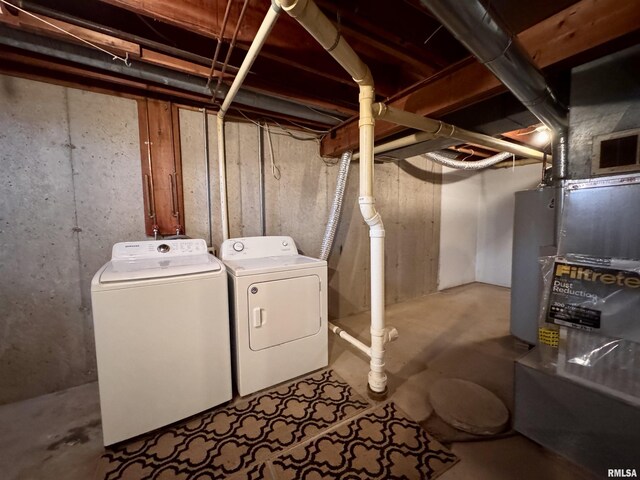 clothes washing area with washer and clothes dryer