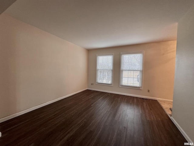 spare room with dark hardwood / wood-style floors