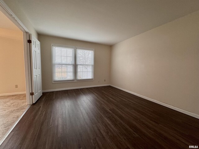 spare room featuring dark hardwood / wood-style flooring