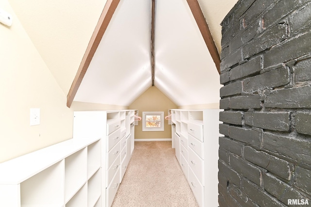 spacious closet featuring light colored carpet and vaulted ceiling