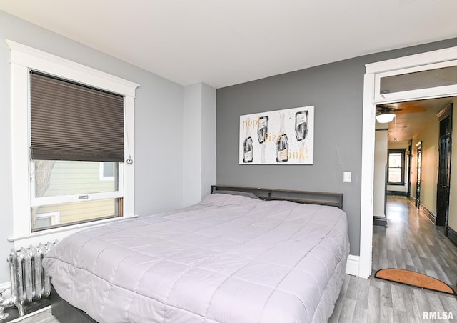 bedroom featuring wood-type flooring and radiator