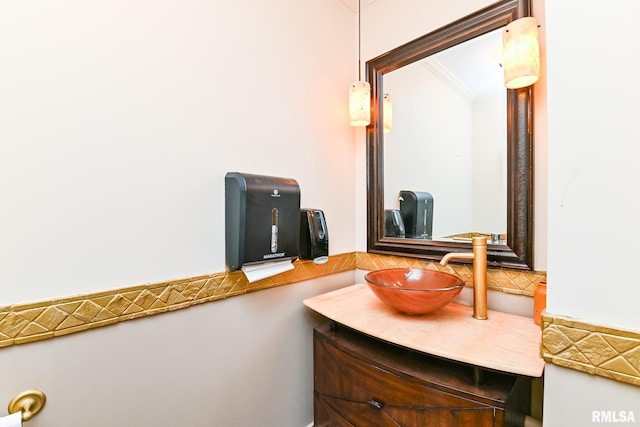 bathroom featuring vanity, ornamental molding, and decorative backsplash