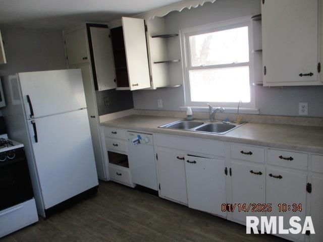 kitchen with white cabinetry, white appliances, dark hardwood / wood-style flooring, and sink