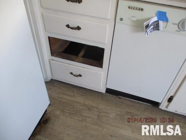 room details with dark hardwood / wood-style floors, dishwasher, and white cabinets