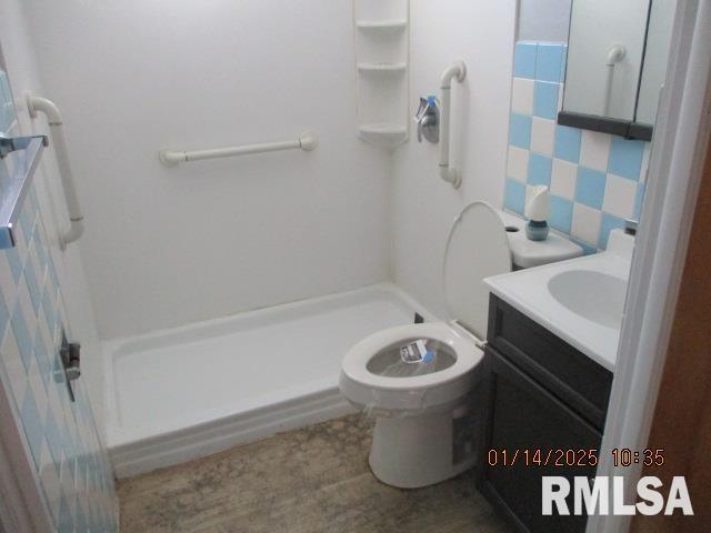 bathroom with vanity, walk in shower, and toilet