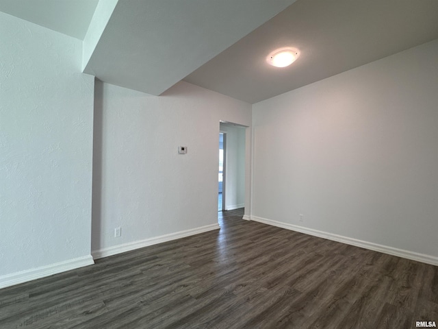 empty room featuring dark wood-type flooring