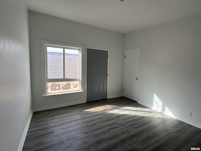 empty room featuring dark wood-type flooring