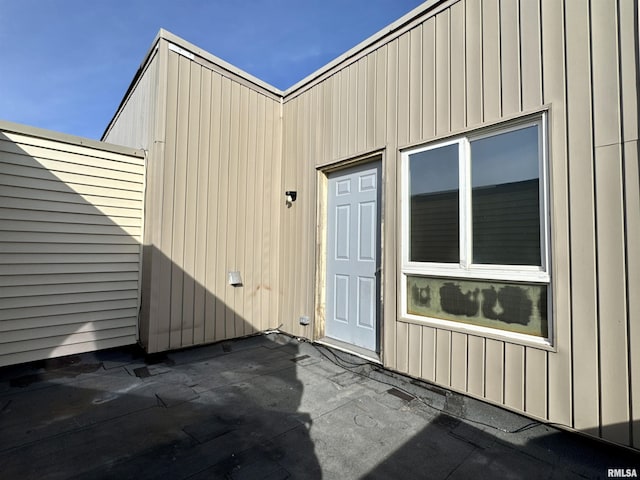 view of exterior entry featuring a patio area