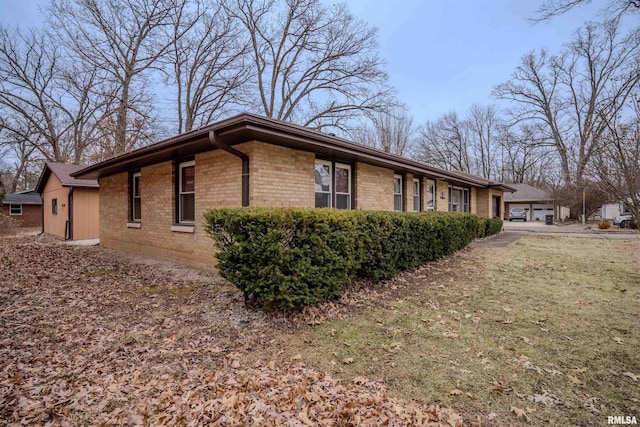 view of side of property with a lawn