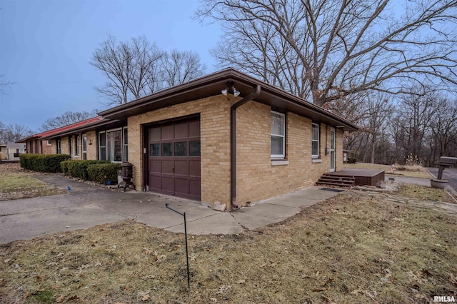 view of property exterior with a garage and a yard