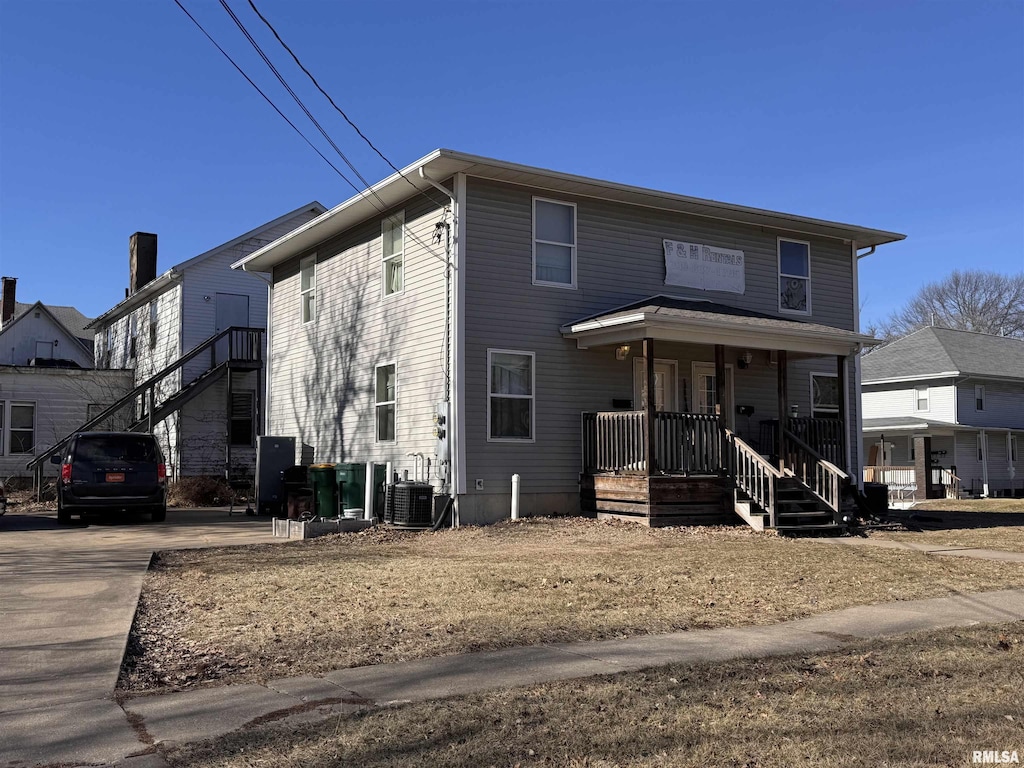 view of front of house with cooling unit and a porch