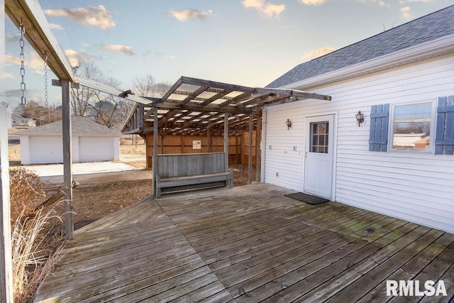 deck at dusk featuring an outbuilding