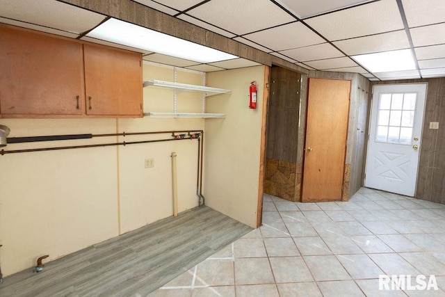 basement featuring a paneled ceiling