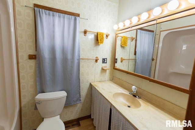 bathroom featuring vanity and toilet