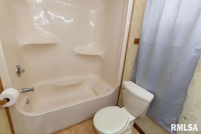 bathroom with toilet and hardwood / wood-style floors